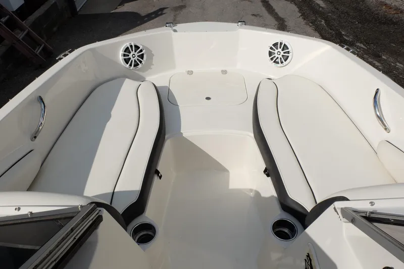 Slide: The Image of 2020 Stingray 191 DC boat interior with white seating and cup holders. - 5
