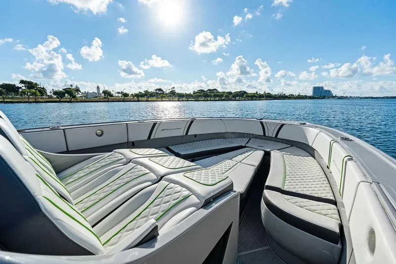 Slide: The Image of 2022 Midnight Express 43' Solstice boat interior with luxurious seating on a sunny day. - 23