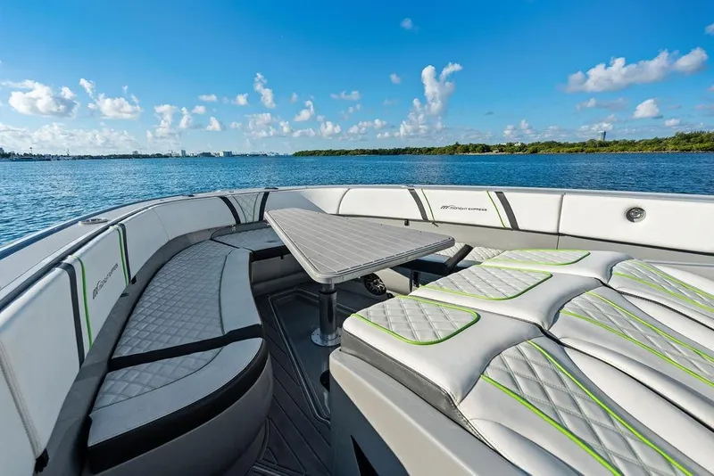 Slide: The Image of Luxurious 2022 Midnight Express 43' Solstice boat interior with seating and table on a sunny day. - 24