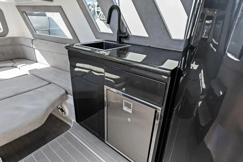 Slide: The Image of Luxurious interior of 2022 Midnight Express 43' Solstice yacht with sleek kitchenette and seating. - 44
