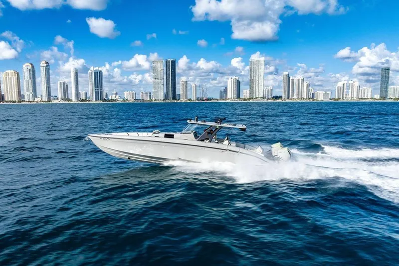 Slide: The Image of 2022 Midnight Express 43' Solstice cruising near city skyline on a sunny day. - 7