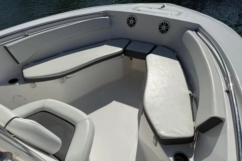 Slide: The Image of Interior seating of 2017 Tidewater 220 CC Adventure boat, featuring cushioned benches and speakers. - 10