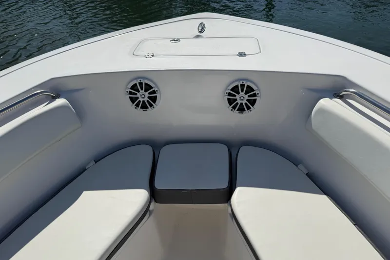 Slide: The Image of Bow seating area of 2017 Tidewater 220 CC Adventure boat with speakers and cushions. - 11