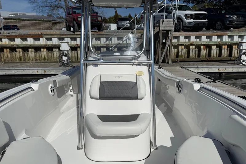 Slide: The Image of 2017 Tidewater 220 CC Adventure boat interior at dock, featuring seating and console. - 13