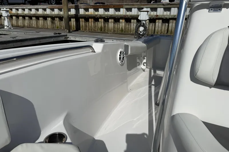 Slide: The Image of 2017 Tidewater 220 CC Adventure boat interior with seating and speaker detail. - 15