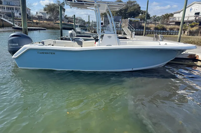 Slide: The Image of 2017 Tidewater 220 CC Adventure boat docked in calm waters. - 22