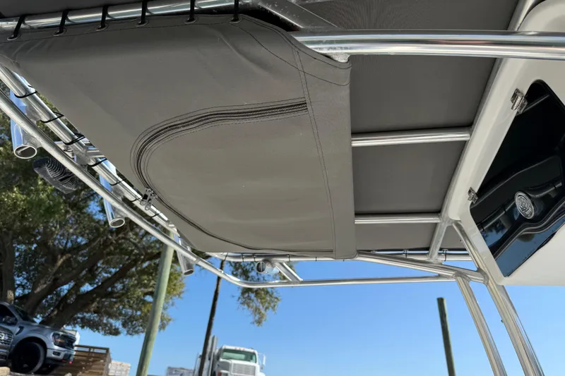 Slide: The Image of Tidewater 220 CC Adventure 2017 boat canopy and storage detail under clear blue sky. - 26