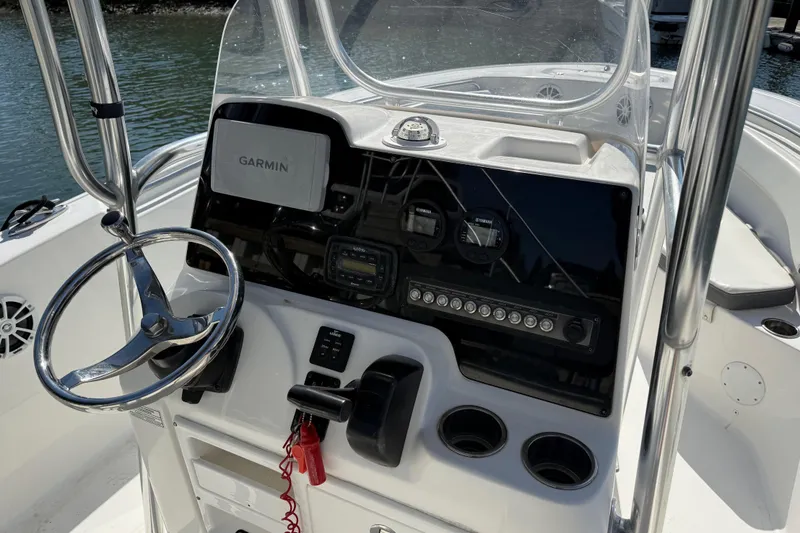 Slide: The Image of 2017 Tidewater 220 CC Adventure boat dashboard with Garmin navigation system and steering wheel. - 27