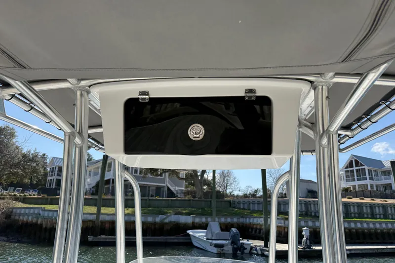 Slide: The Image of Tidewater 220 CC Adventure 2017 boat console with storage compartment, dockside view. - 28