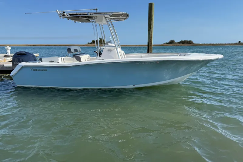 Slide: The Image of 2017 Tidewater 220 CC Adventure boat docked on calm water. - 6