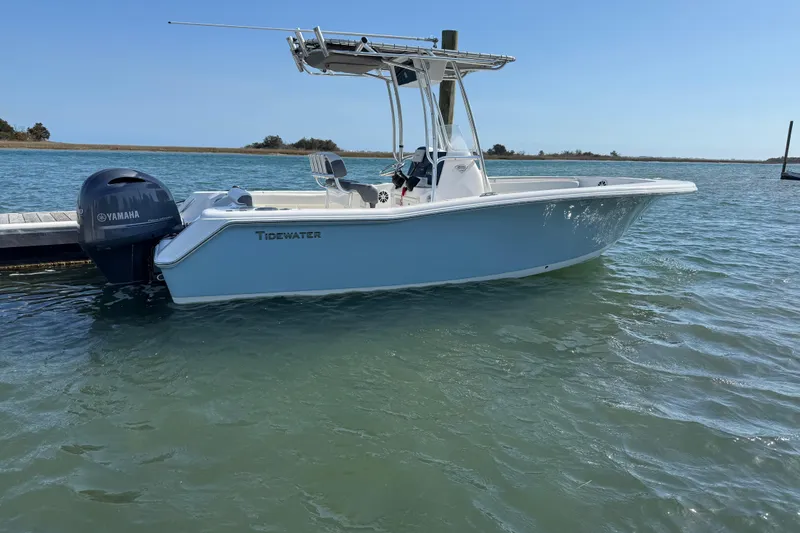 Slide: The Image of 2017 Tidewater 220 CC Adventure boat docked on calm water with Yamaha engine. - 7