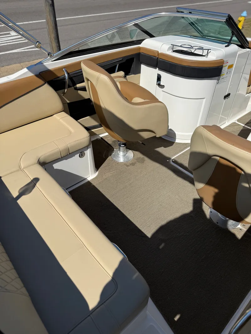 Slide: The Image of Interior of a 2015 Sea Ray 220 Sundeck OB with beige seating. - 12