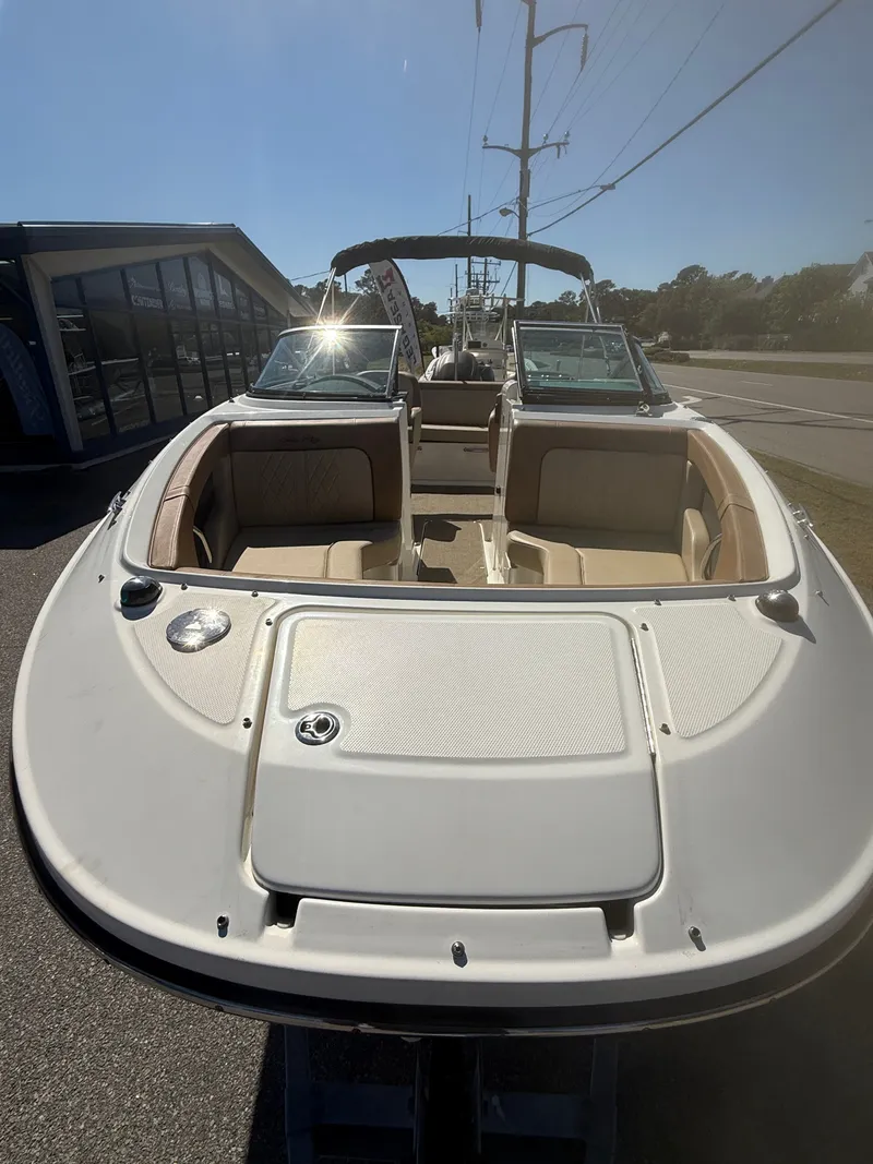 Slide: The Image of 2015 Sea Ray 220 Sundeck OB boat on a parking lot. - 5