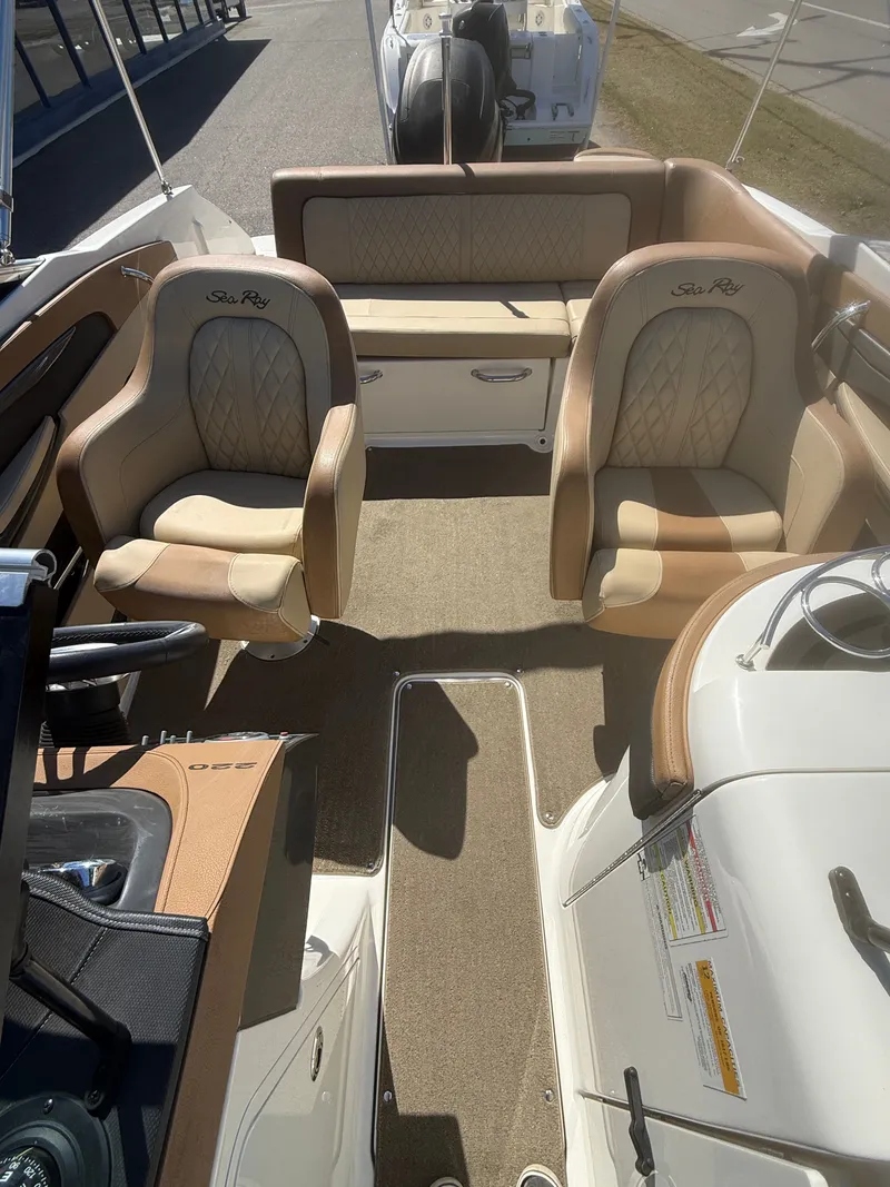 Slide: The Image of Interior of a 2015 Sea Ray 220 Sundeck OB with beige seating. - 8