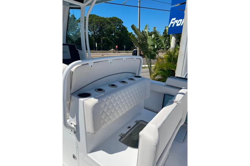 Slide: The Image of 2026 Sea Hunt Ultra 275 Coffin Box boat interior with cushioned seating and cup holders. - 13