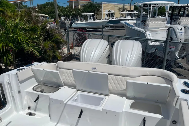 Slide: The Image of 2026 Sea Hunt Ultra 275 Coffin Box boat with open storage compartments and dual Yamaha engines. - 14