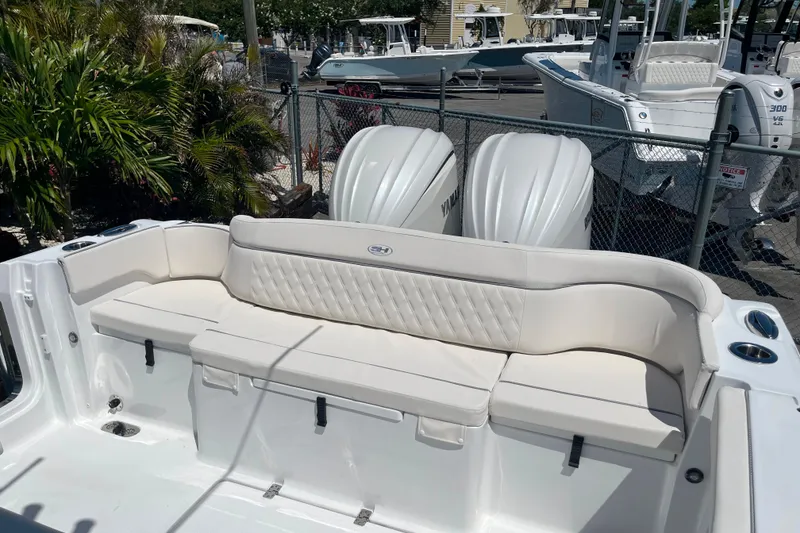 Slide: The Image of 2026 Sea Hunt Ultra 275 Coffin Box boat with cushioned seating and dual Yamaha engines. - 15