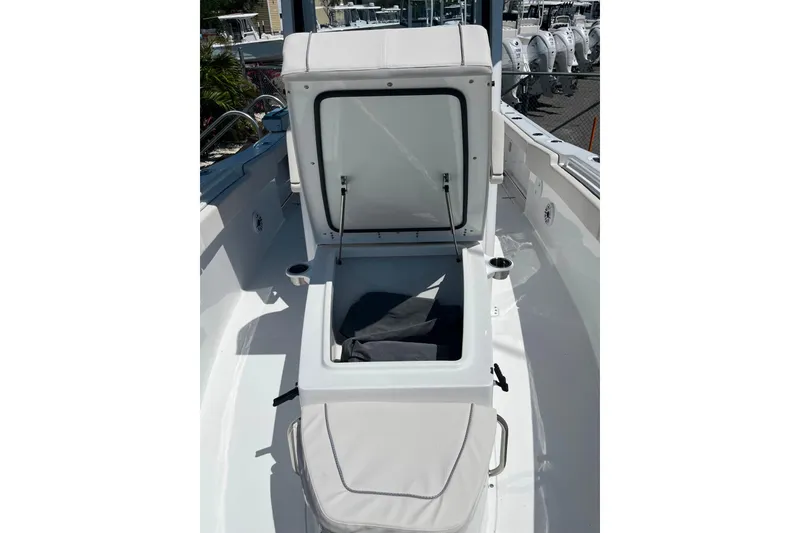 Slide: The Image of 2026 Sea Hunt Ultra 275 Coffin Box open on deck, showcasing storage space. - 16