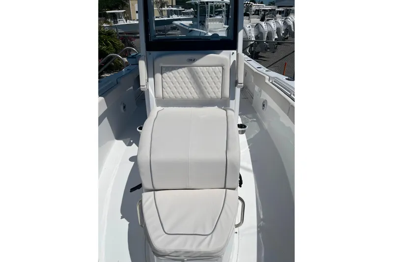 Slide: The Image of 2026 Sea Hunt Ultra 275 Coffin Box boat interior with cushioned seating. - 17