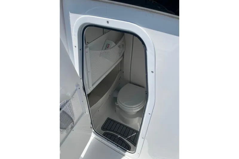 Slide: The Image of Interior view of 2026 Sea Hunt Ultra 275 Coffin Box boat's compact bathroom. - 18