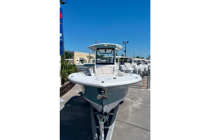 Slide: The Image of 2026 Sea Hunt Ultra 275 Coffin Box boat displayed outdoors under clear blue sky. - 3