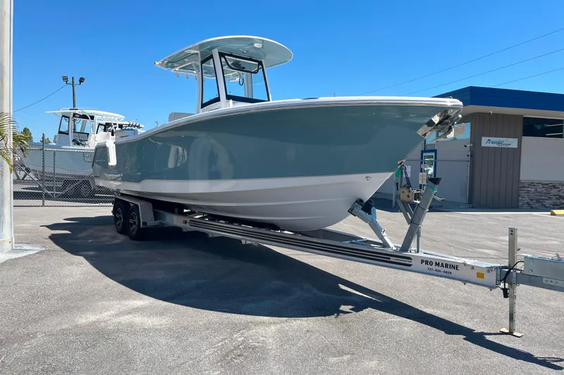 Slide: The Image of 2026 Sea Hunt Ultra 275 Coffin Box boat on trailer, displayed outdoors. - 4