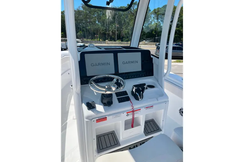 Slide: The Image of 2026 Sea Hunt Ultra 275 Coffin Box helm with dual Garmin displays and steering wheel. - 8
