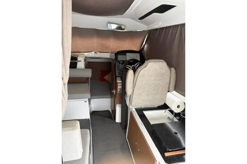 Slide: The Image of Interior of 2019 Jeanneau NC 795 boat with helm, seating, and kitchenette. - 4