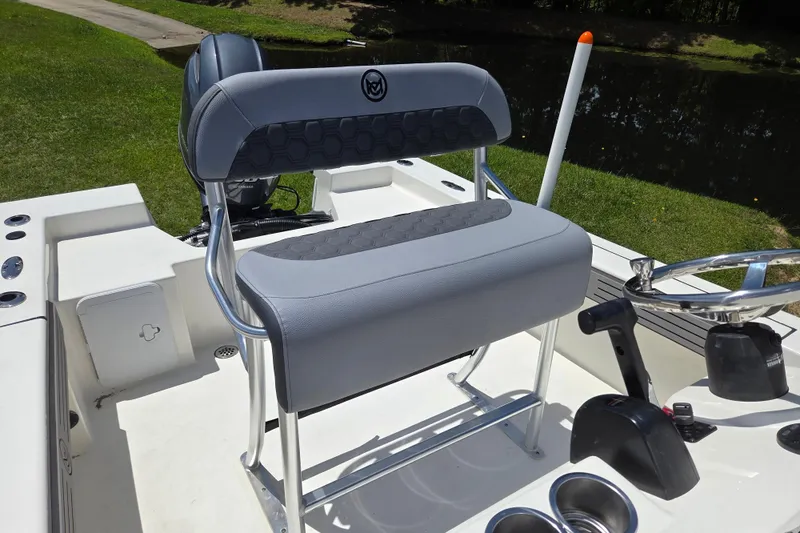 Slide: The Image of 2026 May-Craft 182 Center Console boat interior with sleek seating and steering wheel. - 11