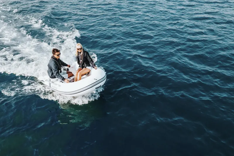 Slide: The Image of Two people enjoying a ride on a 2026 Highfield Ultralite 240 inflatable boat. - 5