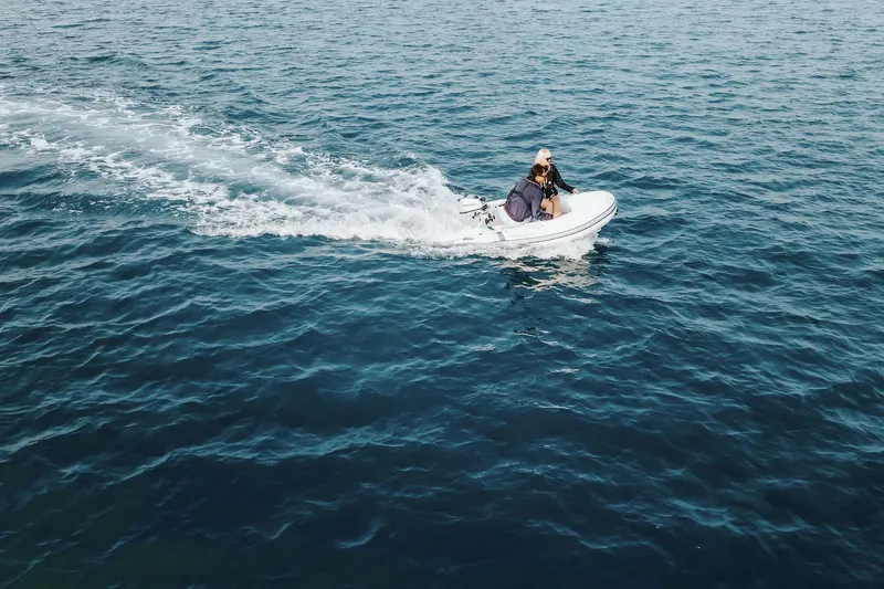 Slide: The Image of Person riding a 2026 Highfield Ultralite 240 boat on open water. - 6