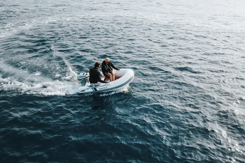Slide: The Image of Two people on a 2026 Highfield Ultralite 240 boat cruising on open water. - 7