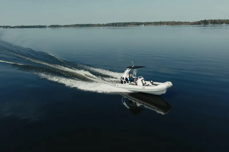 Slide: The Image of 2026 Highfield Sport 520 boat cruising on calm lake waters. - 5