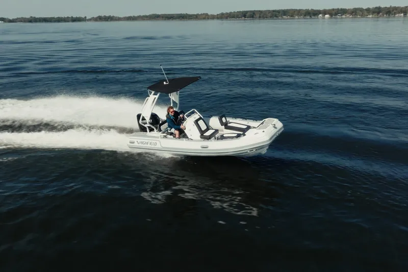 Slide: The Image of 2026 Highfield Sport 520 boat cruising on a calm lake. - 6