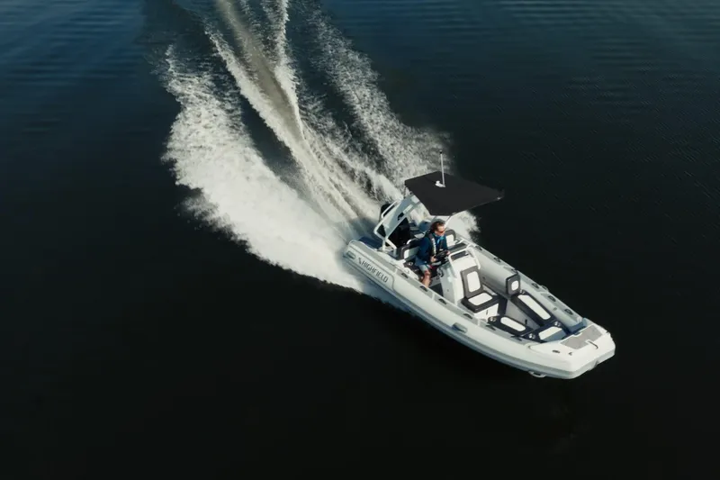 Slide: The Image of 2026 Highfield Sport 520 boat cruising on calm water, creating a dynamic wake. - 7