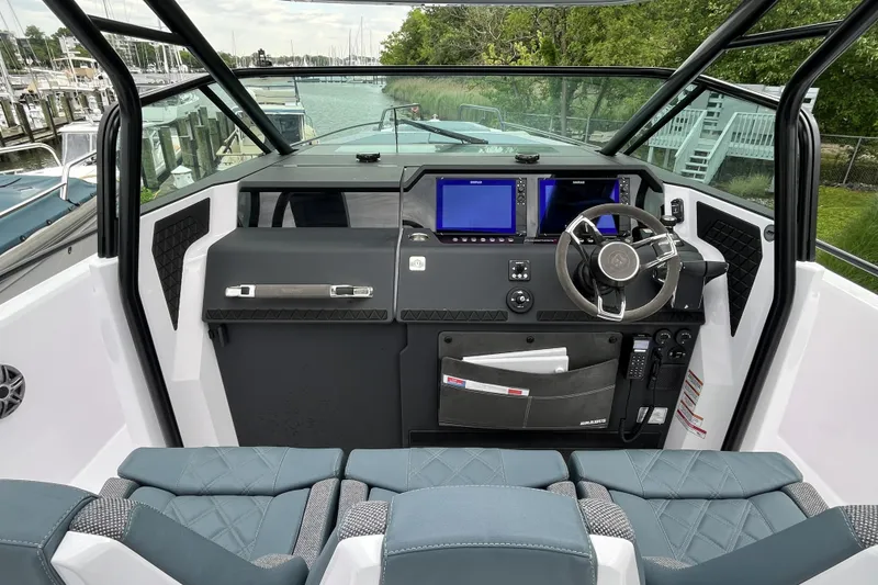 Slide: The Image of 2025 Axopar 37 Sun-Top boat cockpit with modern dashboard and steering wheel. - 13