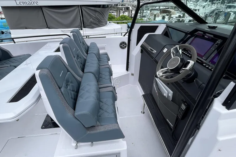 Slide: The Image of 2025 Axopar 37 Sun-Top boat interior with modern seating and advanced dashboard controls. - 16