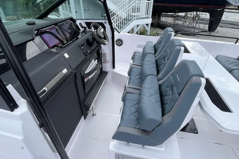 Slide: The Image of 2025 Axopar 37 Sun-Top boat interior with modern dashboard and luxurious seating. - 18