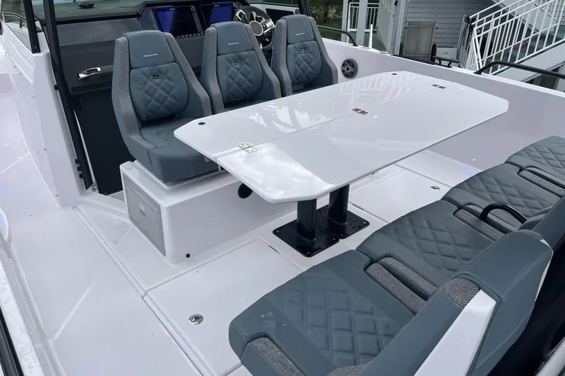 Slide: The Image of 2025 Axopar 37 Sun-Top boat interior with sleek seating and modern design. - 19