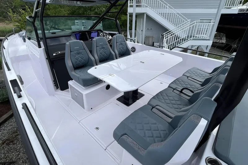 Slide: The Image of 2025 Axopar 37 Sun-Top boat interior with modern seating and sleek design. - 21