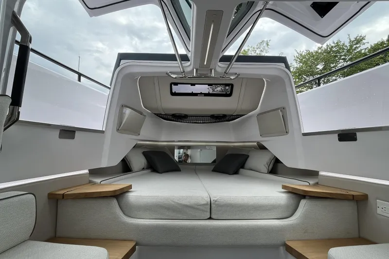 Slide: The Image of 2025 Axopar 37 Sun-Top cabin interior with modern design and comfortable seating. - 33