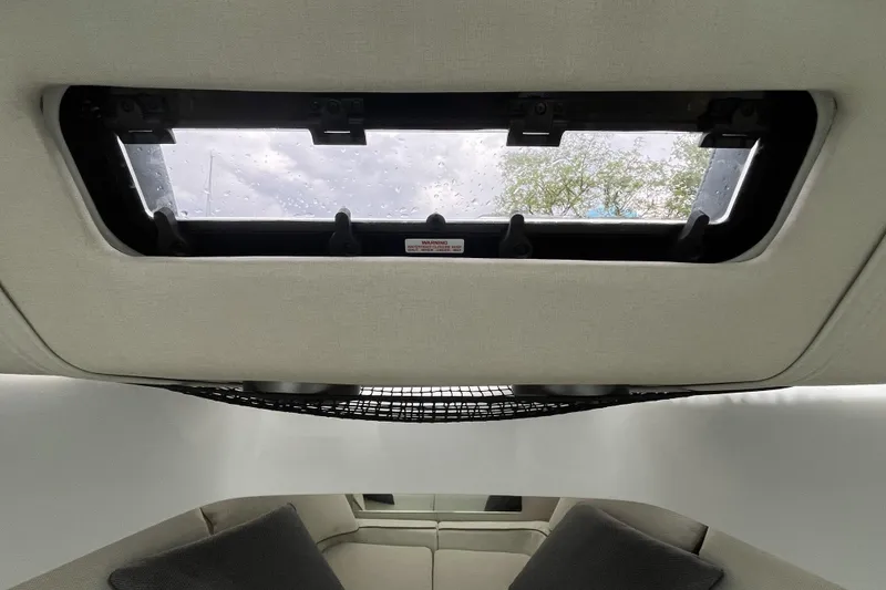 Slide: The Image of Interior view of 2025 Axopar 37 Sun-Top boat with skylight and seating area. - 37
