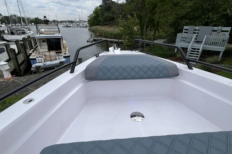 Slide: The Image of 2025 Axopar 37 Sun-Top boat docked, featuring sleek design and comfortable seating. - 40