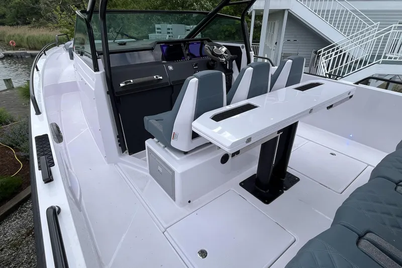 Slide: The Image of 2025 Axopar 37 Sun-Top boat interior with sleek seating and modern dashboard design. - 53
