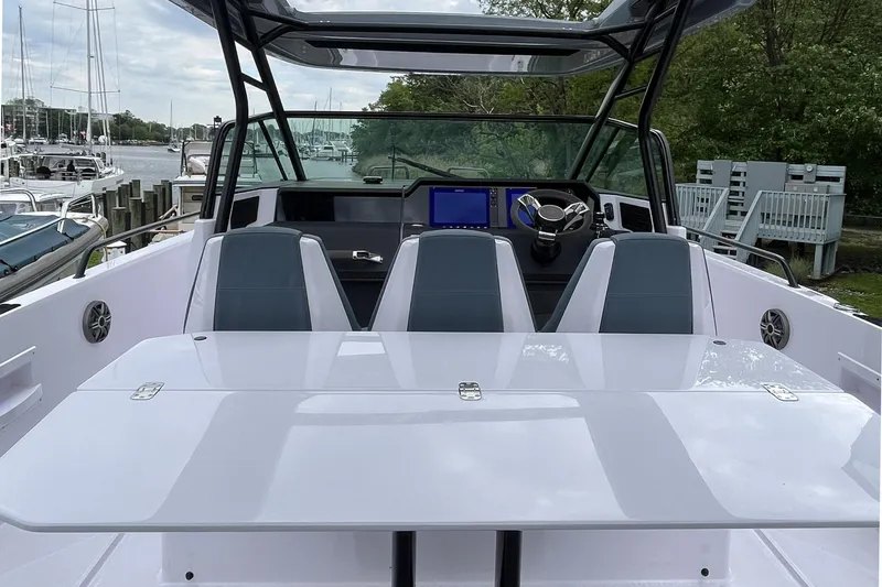 Slide: The Image of 2025 Axopar 37 Sun-Top boat interior with sleek seating and modern dashboard. - 55