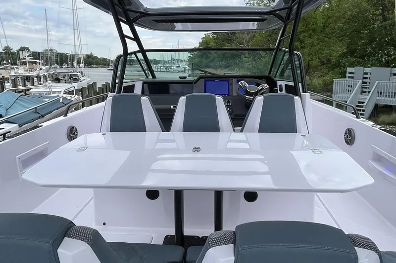 Slide: The Image of 2025 Axopar 37 Sun-Top boat interior with sleek seating and modern dashboard. - 56