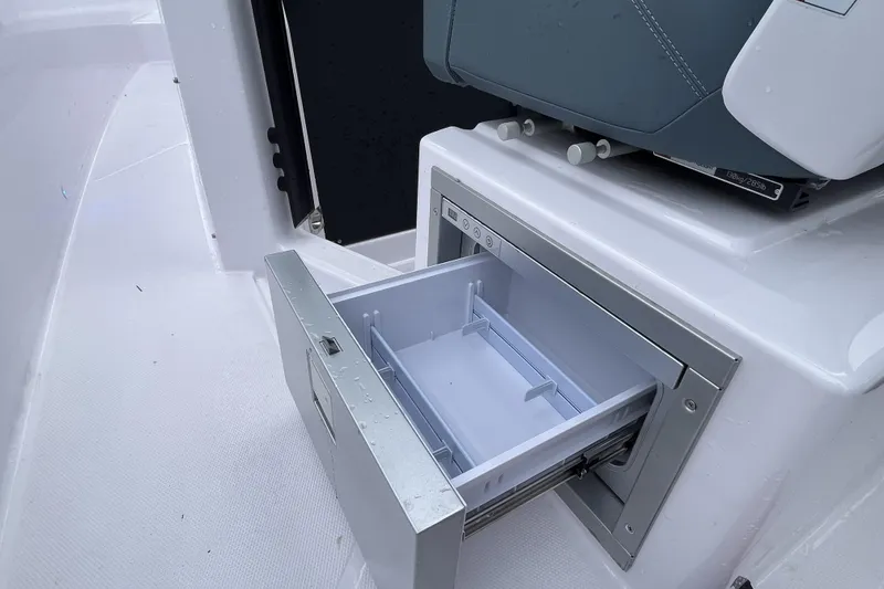 Slide: The Image of Open storage compartment on 2025 Axopar 37 Sun-Top boat, showcasing sleek design and functionality. - 58