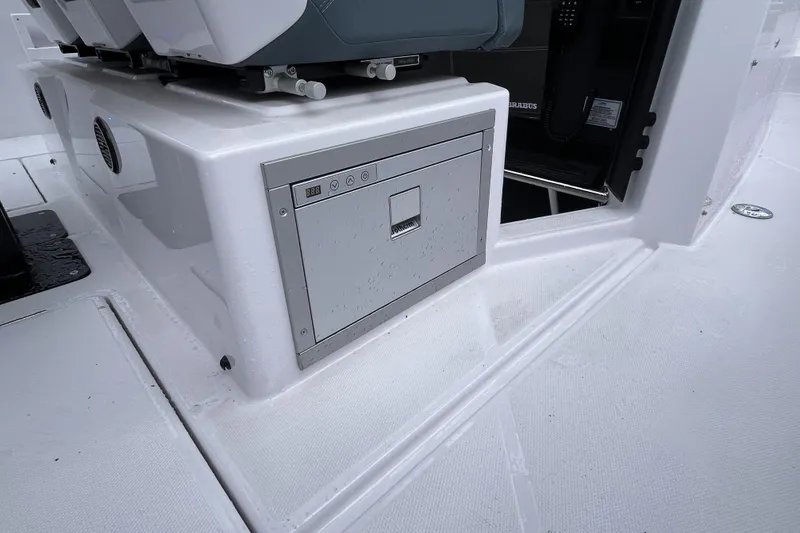 Slide: The Image of 2025 Axopar 37 Sun-Top boat interior with storage compartment and seating. - 59