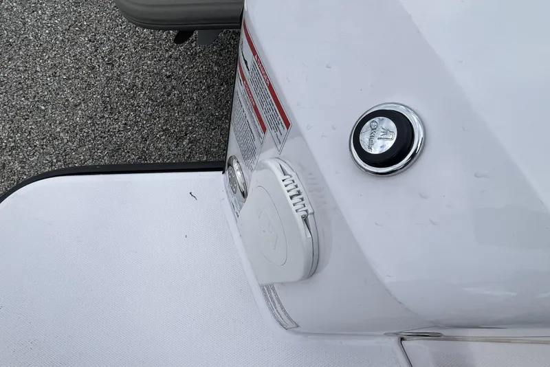 Slide: The Image of 2025 Axopar 37 Sun-Top boat detail with chrome fuel cap and warning labels. - 61