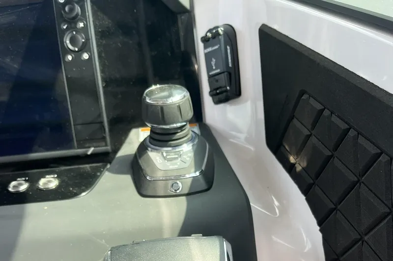 Slide: The Image of Control panel of 2025 Axopar 37 Sun-Top boat, featuring joystick and USB port. - 64